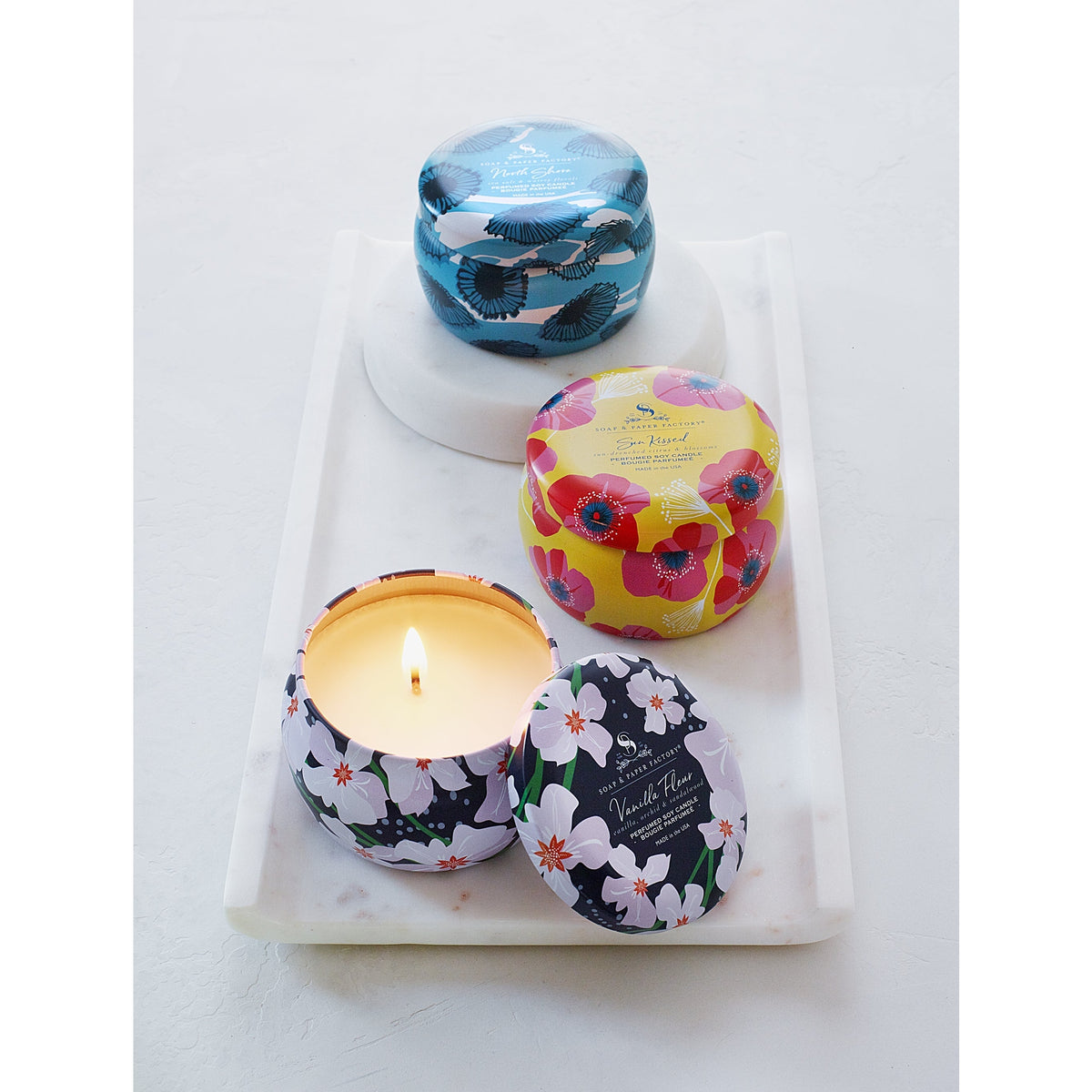 Soap &amp; Paper Factory Small Tin Candle Trio Sun Kissed Citrus, North Shore, Vanilla Fleur set of 3, 3oz burn time 18 hours - Brought to you by Luxe &amp; Lark